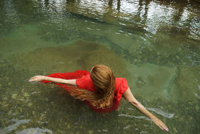 High angle view of woman swimming in lake