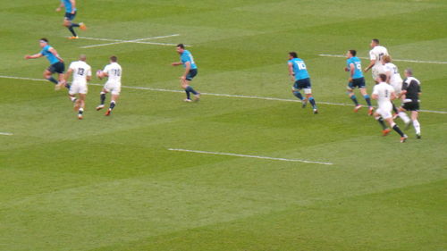 People playing soccer on grassy field