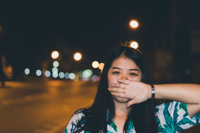 Portrait of young woman at night