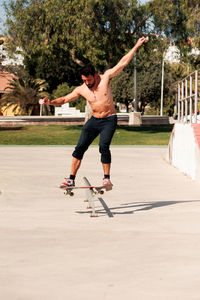 Boy doing skateboard trick on rail