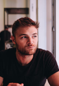 Portrait of young man at home