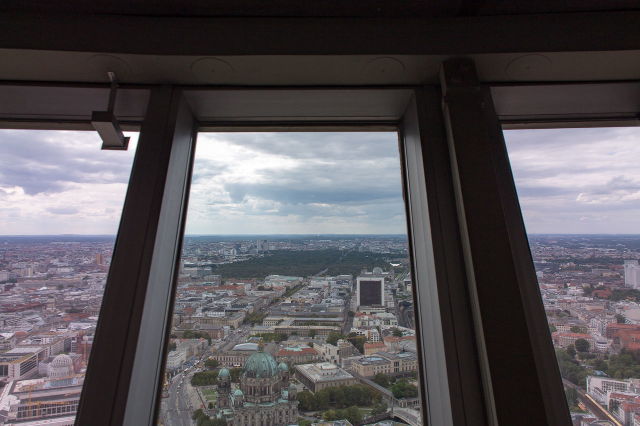 VIEW OF CITYSCAPE AGAINST CLOUDY SKY