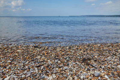 View of pebbles on beach against sky