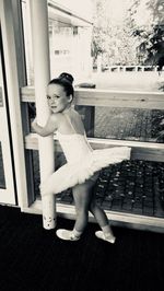 Full length portrait of girl standing in corridor