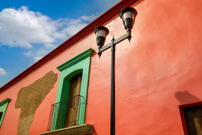 Low angle view of street light against building