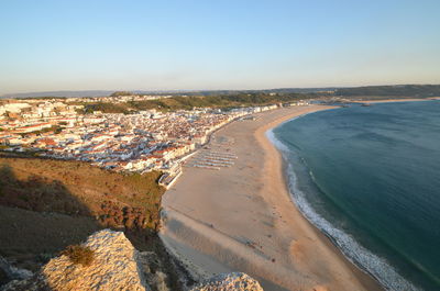 High angle view of sea and buildings against sky