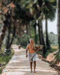 Full length of man walking on footpath