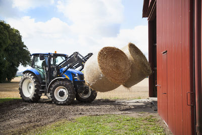 Tractor carry bale of hay