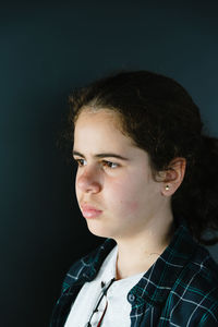 Close-up of girl against wall