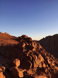 Rock formations on landscape against clear sky