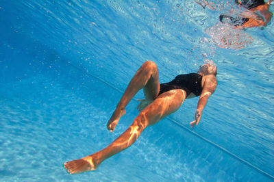 Full length of woman swimming underwater in pool