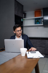 Businessman working at desk in office cafeteria