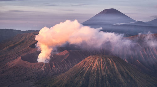 Volcanic landscape against sky during sunset