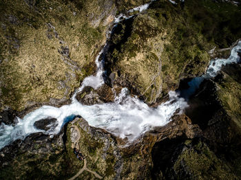 High angle view of waterfall along rocks