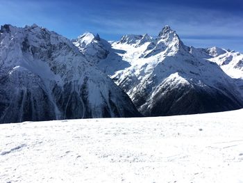 Scenic view of snow covered mountains against sky
