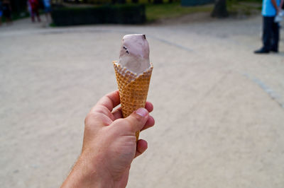 Cropped image of man holding ice cream