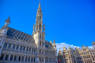 Low angle view of buildings against blue sky