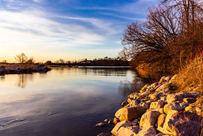 Scenic view of lake against sky during sunset