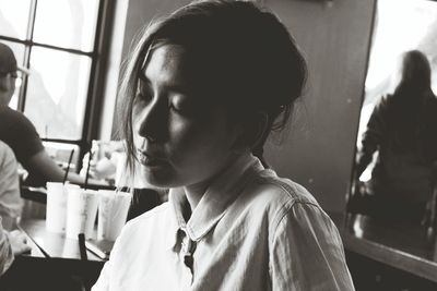 Close-up of woman with closed eyes at cafe