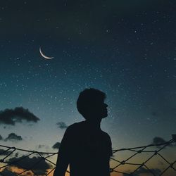 Low angle view of silhouette man against sky at night