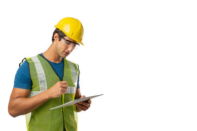 Young man wearing hat standing against white background