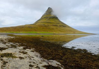 Scenic view of lake against cloudy sky