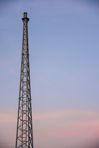 Low angle view of communications tower against sky during sunset