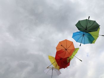 Low angle view of multi colored umbrella against sky