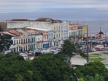 High angle view of buildings and street by sea