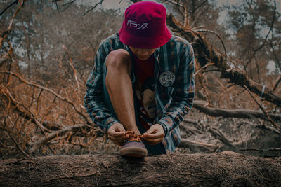 Full length of man sitting in forest