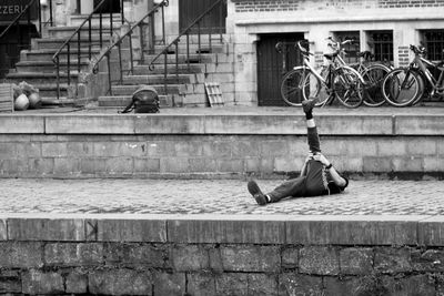 Man on retaining wall in city