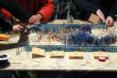 People working with cables at table