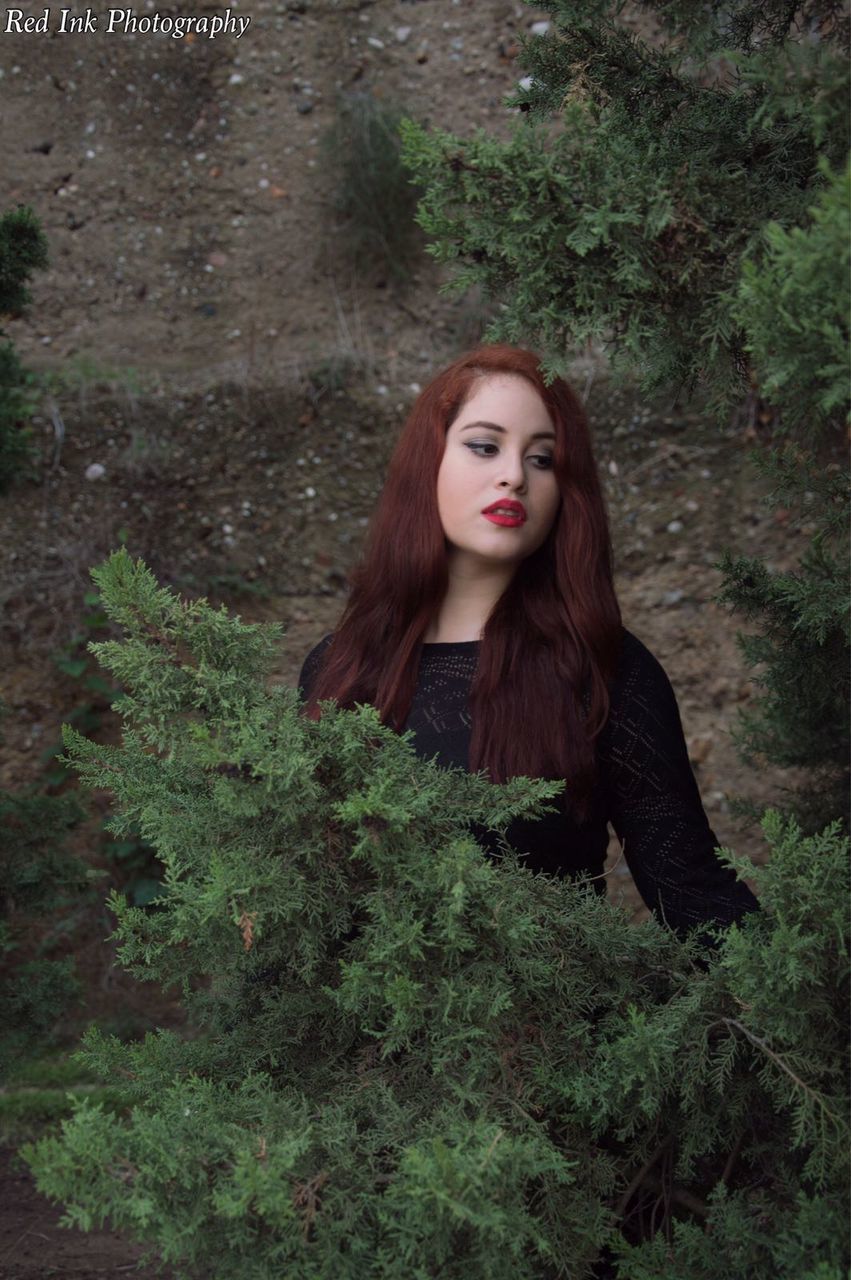 PORTRAIT OF YOUNG WOMAN WITH RED HAIR