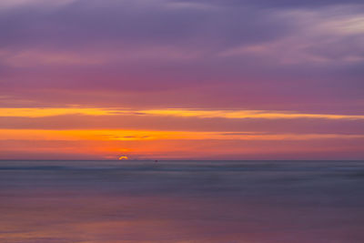 Scenic view of sea against romantic sky at sunset