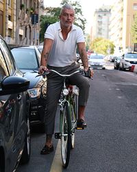 Portrait of smiling man standing on motorcycle