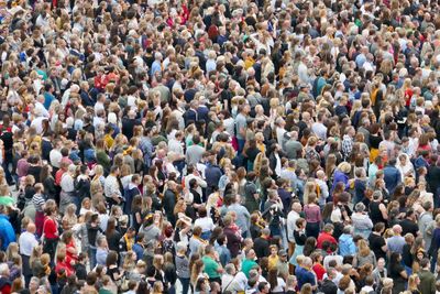 High angle view of group of people standing in city