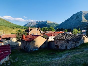 Houses on mountain against blue sky