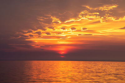 Scenic view of sea against romantic sky at sunset