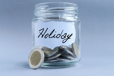 Close-up of coins on glass against white background