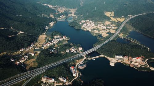 High angle view of river amidst field in city