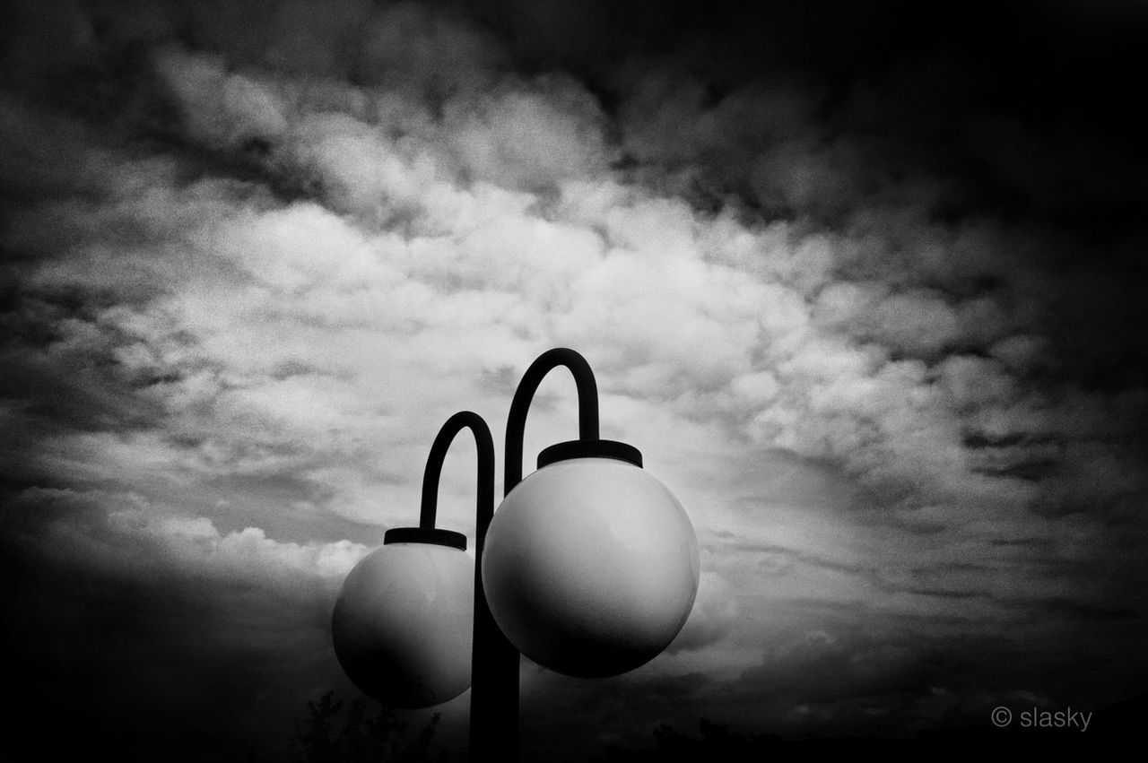 low angle view, sky, cloud - sky, lighting equipment, cloudy, street light, cloud, no people, outdoors, sphere, electric light, dusk, electricity, illuminated, circle, weather, technology, overcast, nature, night