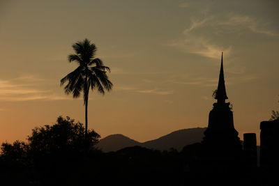 Silhouette of palm trees against sky at sunset