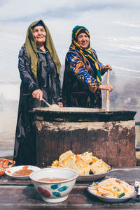 Woman standing by food on table during winter