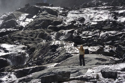 Young woman standing on rock formation