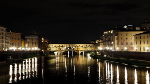 Bridge over canal in city at night