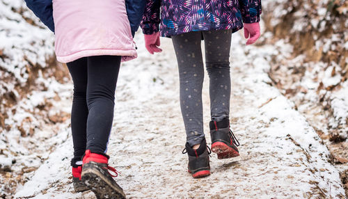 Low section of women walking outdoors