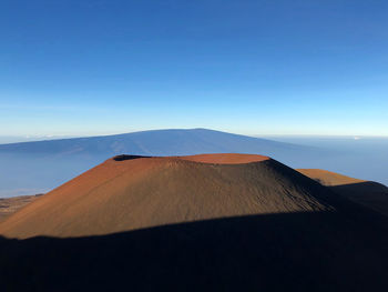 Scenic view of mountain and volcanic crater against blue sky on big island of hawaii