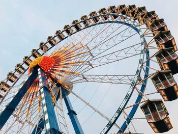 Low angle view of ferris wheel against sky