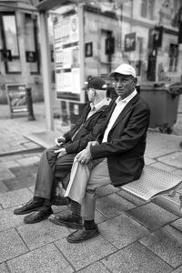 Portrait of man sitting on floor in city