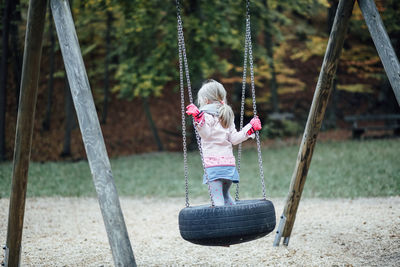 Rear view of women on swing at playground